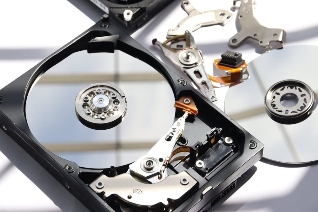 Detailed view of disassembled HDD showing intricate internal components.